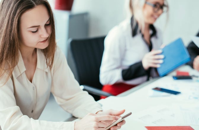 Employee on her phone during a team meeting